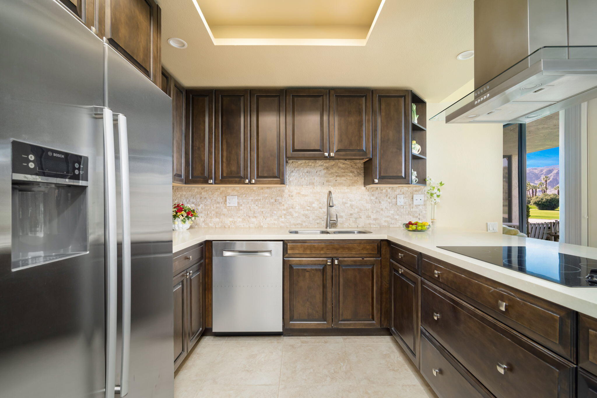 910 Island Drive, Unit 116 Rancho Mirage, CA 92270 - Photo 14 of 39 a kitchen with stainless steel appliances granite countertop a sink and a refrigerator