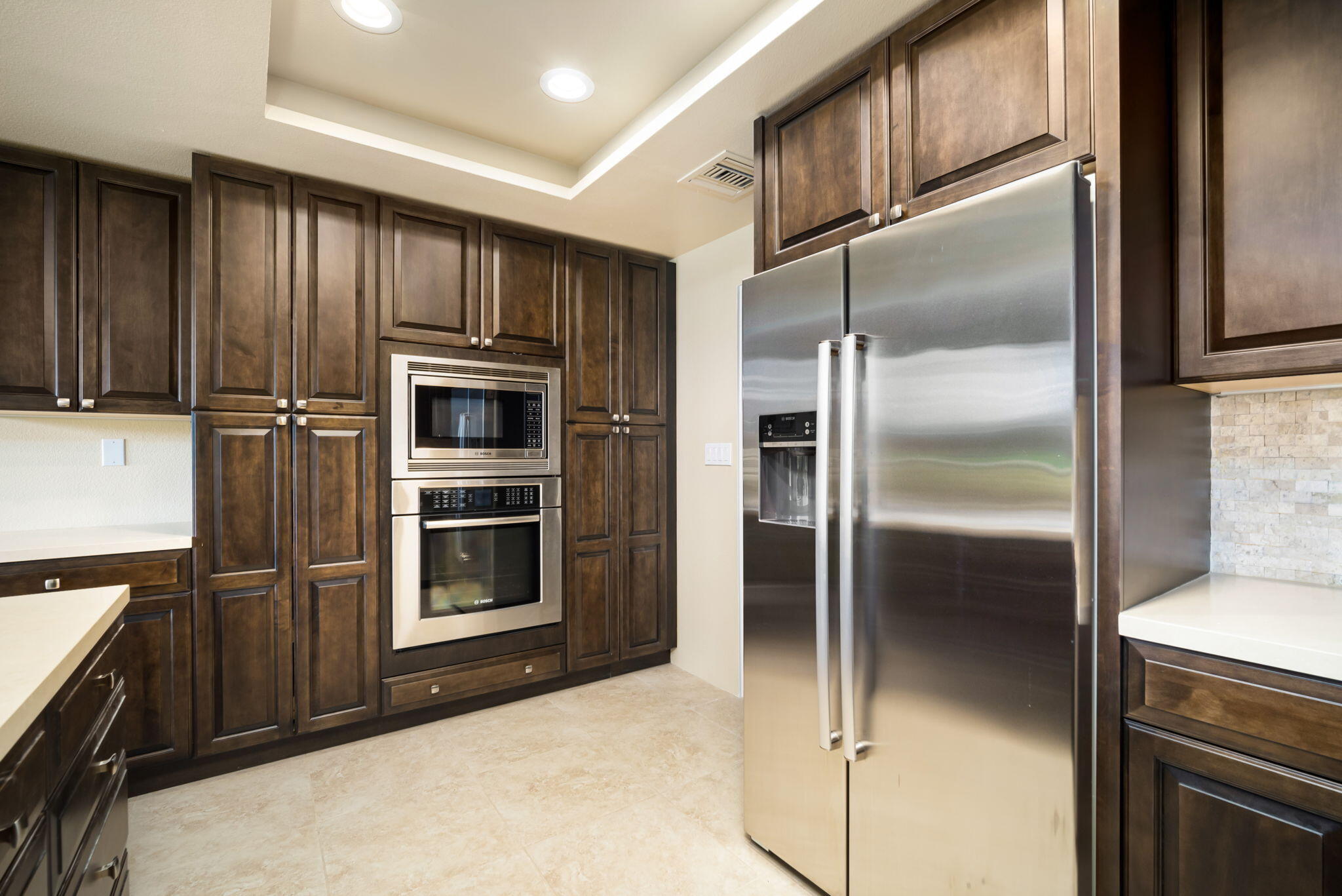 910 Island Drive, Unit 116 Rancho Mirage, CA 92270 - Photo 15 of 39 a kitchen with granite countertop stainless steel appliances and a refrigerator
