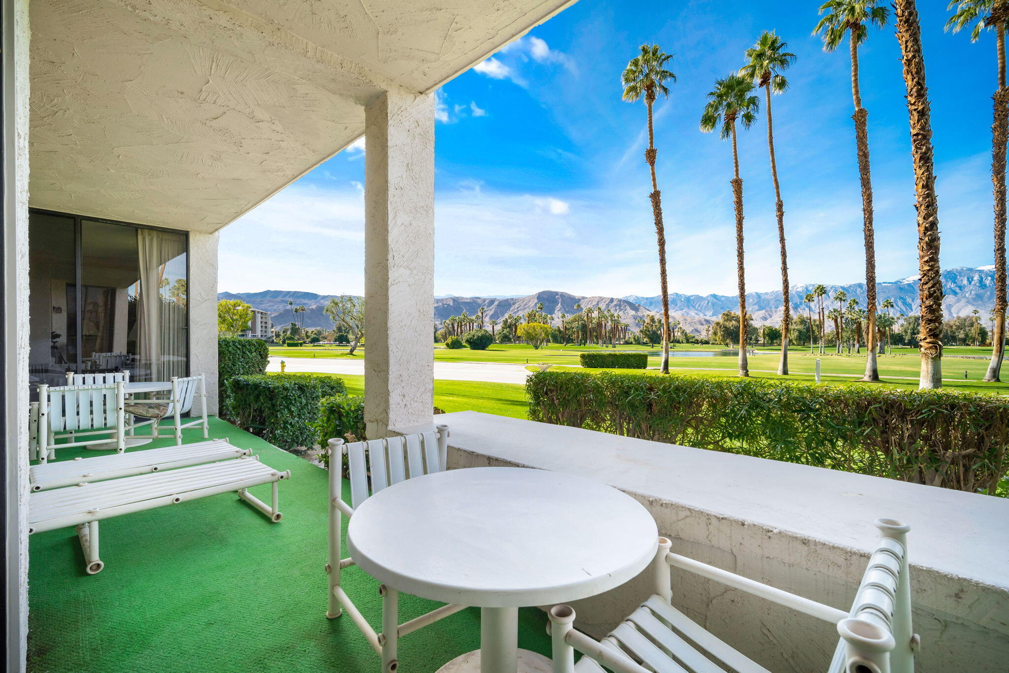 910 Island Drive, Unit 116 Rancho Mirage, CA 92270 - Photo 18 of 39 a view of a patio with a table chairs and a backyard
