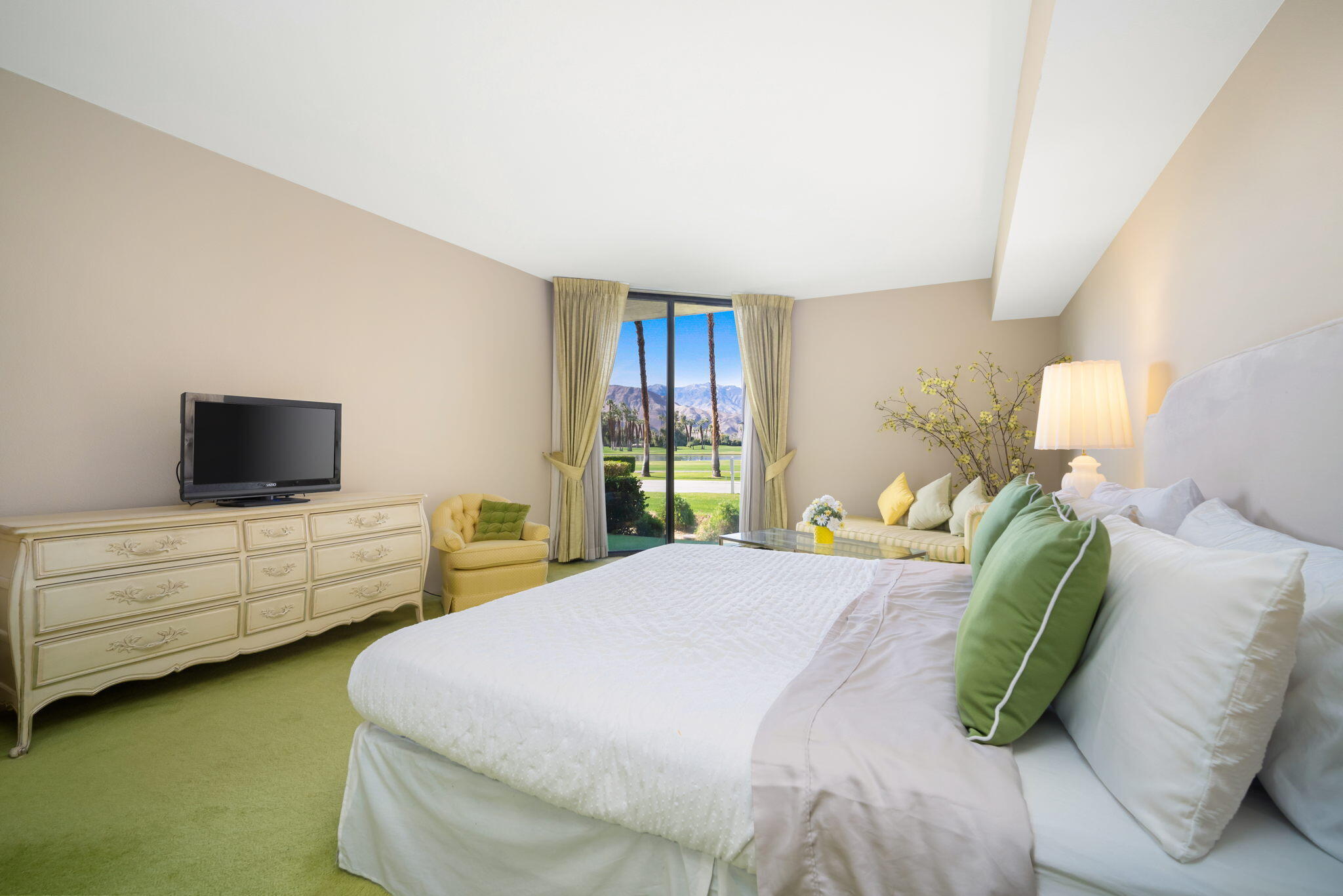 910 Island Drive, Unit 116 Rancho Mirage, CA 92270 - Photo 27 of 39 a bedroom with a bed and flat screen tv