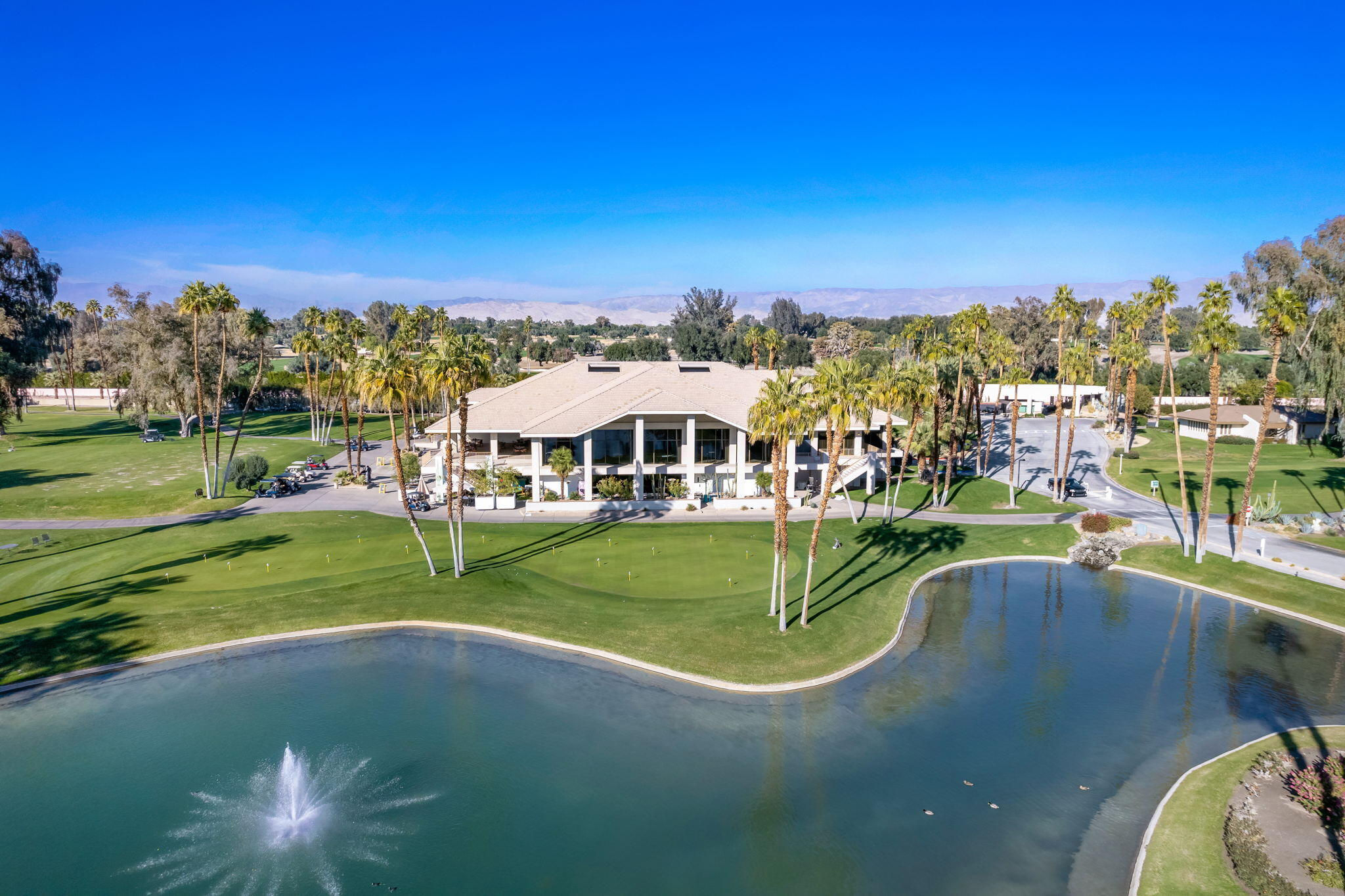 910 Island Drive, Unit 116 Rancho Mirage, CA 92270 - Photo 35 of 39 a view of a swimming pool with a yard