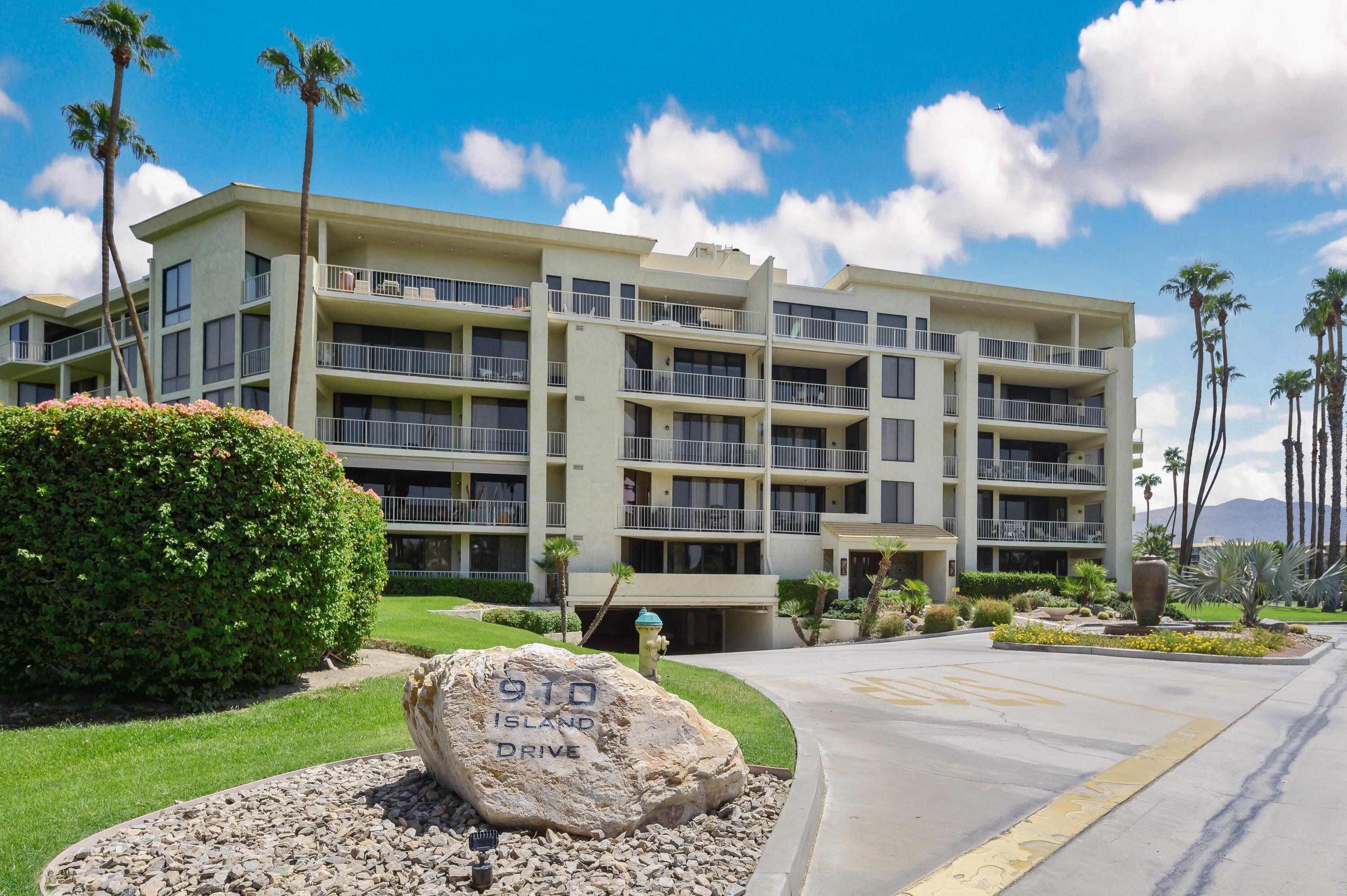 910 Island Drive, Unit 116 Rancho Mirage, CA 92270 - Photo 38 of 39 a front view of a building with a garden