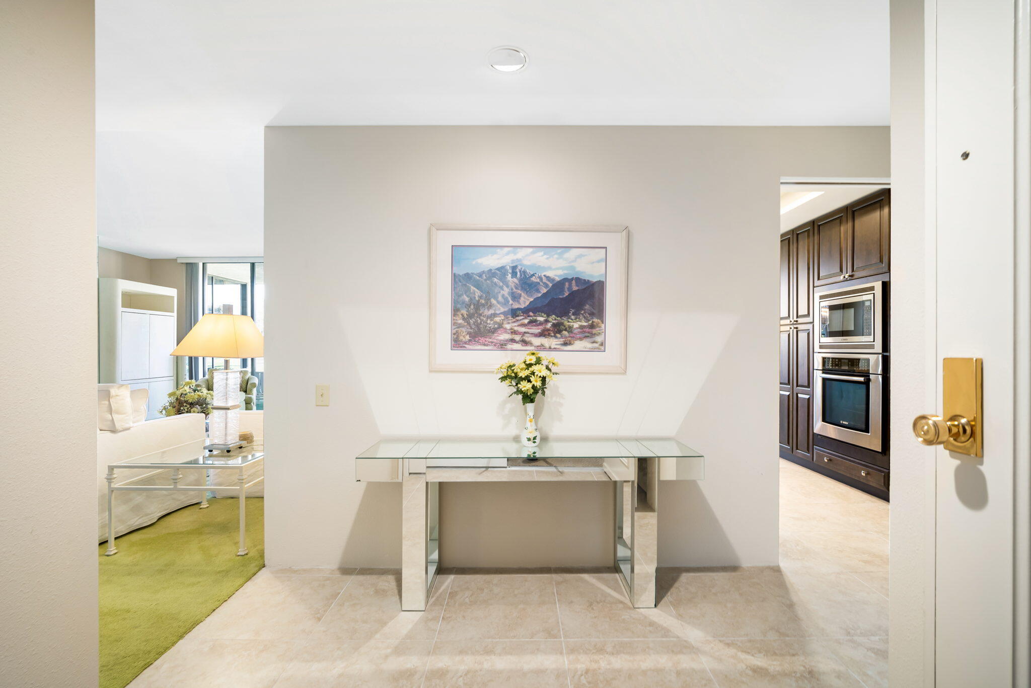 910 Island Drive, Unit 116 Rancho Mirage, CA 92270 - Photo 6 of 39 a living room with furniture and a wall painting