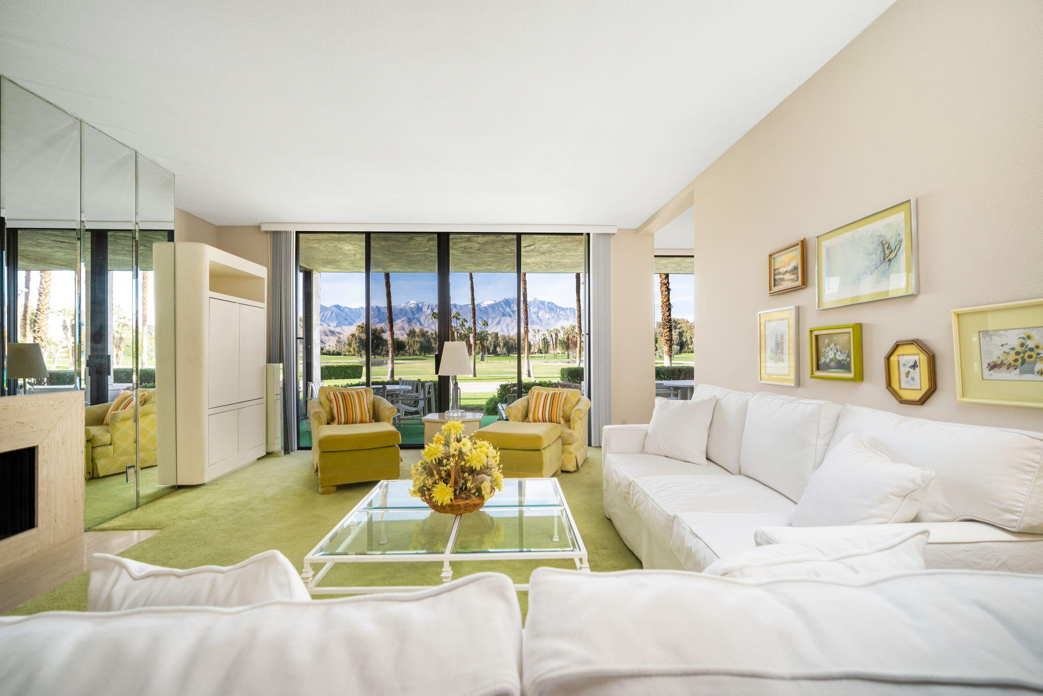 910 Island Drive, Unit 116 Rancho Mirage, CA 92270 - Photo 10 of 39 a living room with furniture and a large window