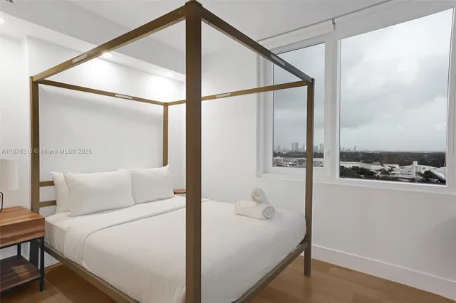 a bedroom with a bed and a dresser with mirror