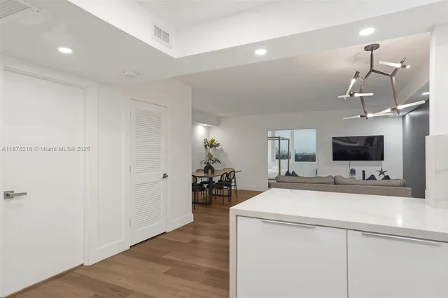 a room with a sink and a flat screen tv
