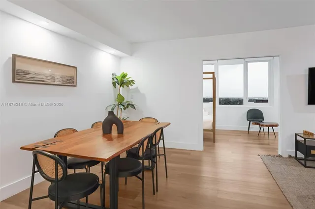 a dining room with furniture and wooden floor