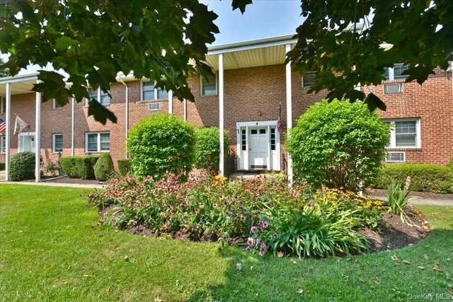 front view of a house with a tree