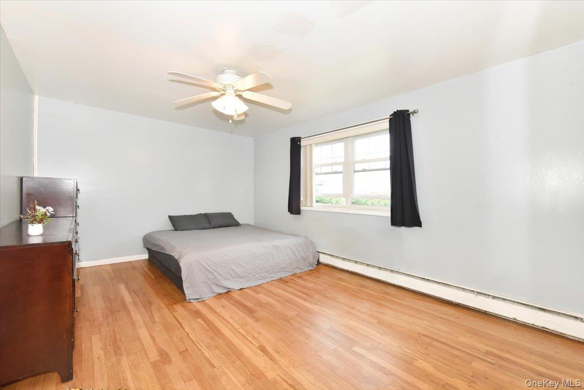 295 Merrick Road, Unit 4A Amityville, NY 11701 - Photo 11 of 16 a bedroom with a bed and a window