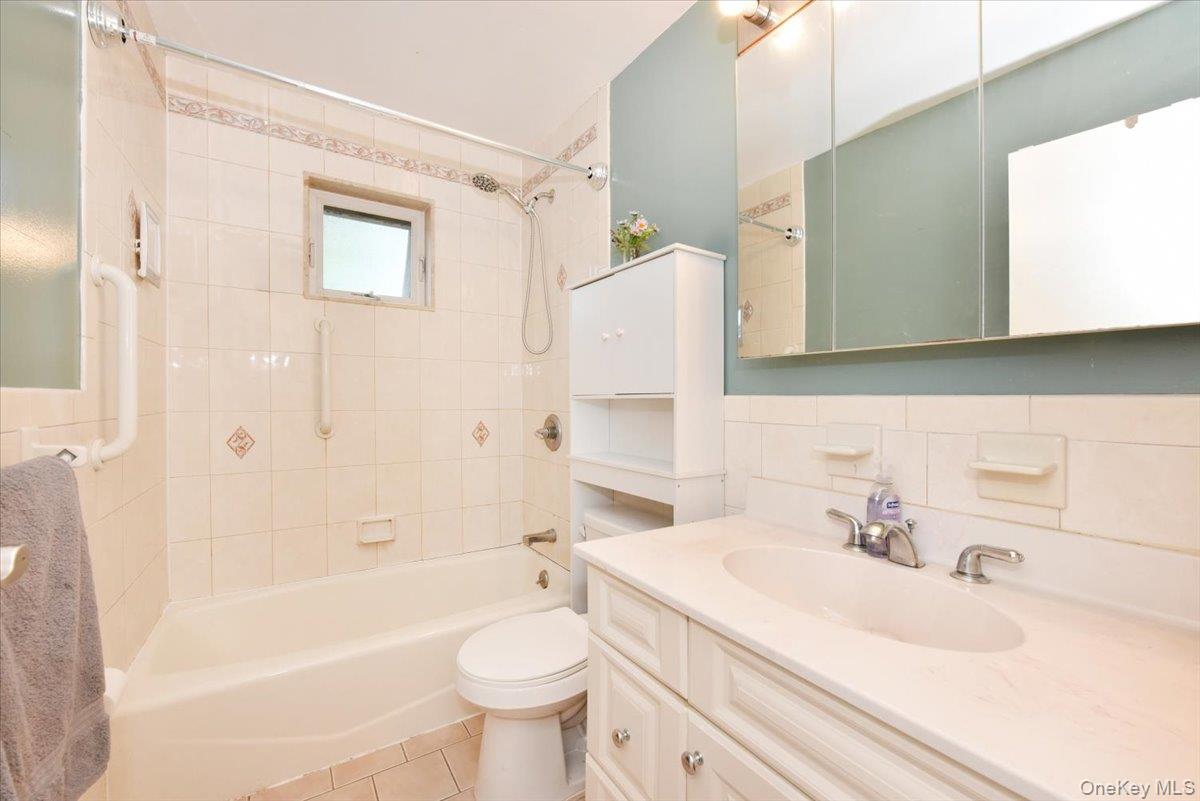 295 Merrick Road, Unit 4A Amityville, NY 11701 - Photo 13 of 16 a bathroom with a sink toilet and shower