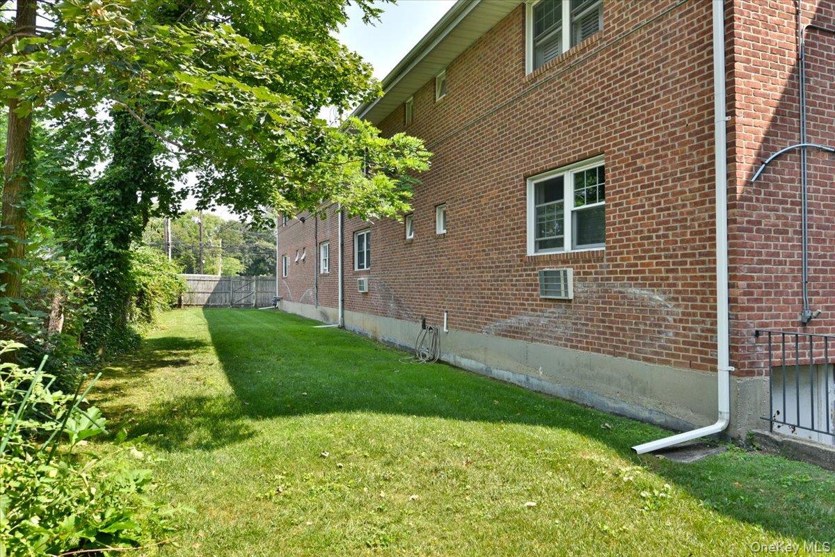295 Merrick Road, Unit 4A Amityville, NY 11701 - Photo 15 of 16 a backyard of a house with lots of green space