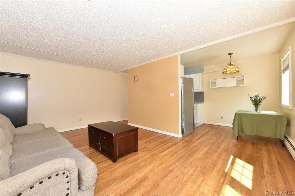 295 Merrick Road, Unit 4A Amityville, NY 11701 - Photo 6 of 16 a bedroom with a bed and a couch