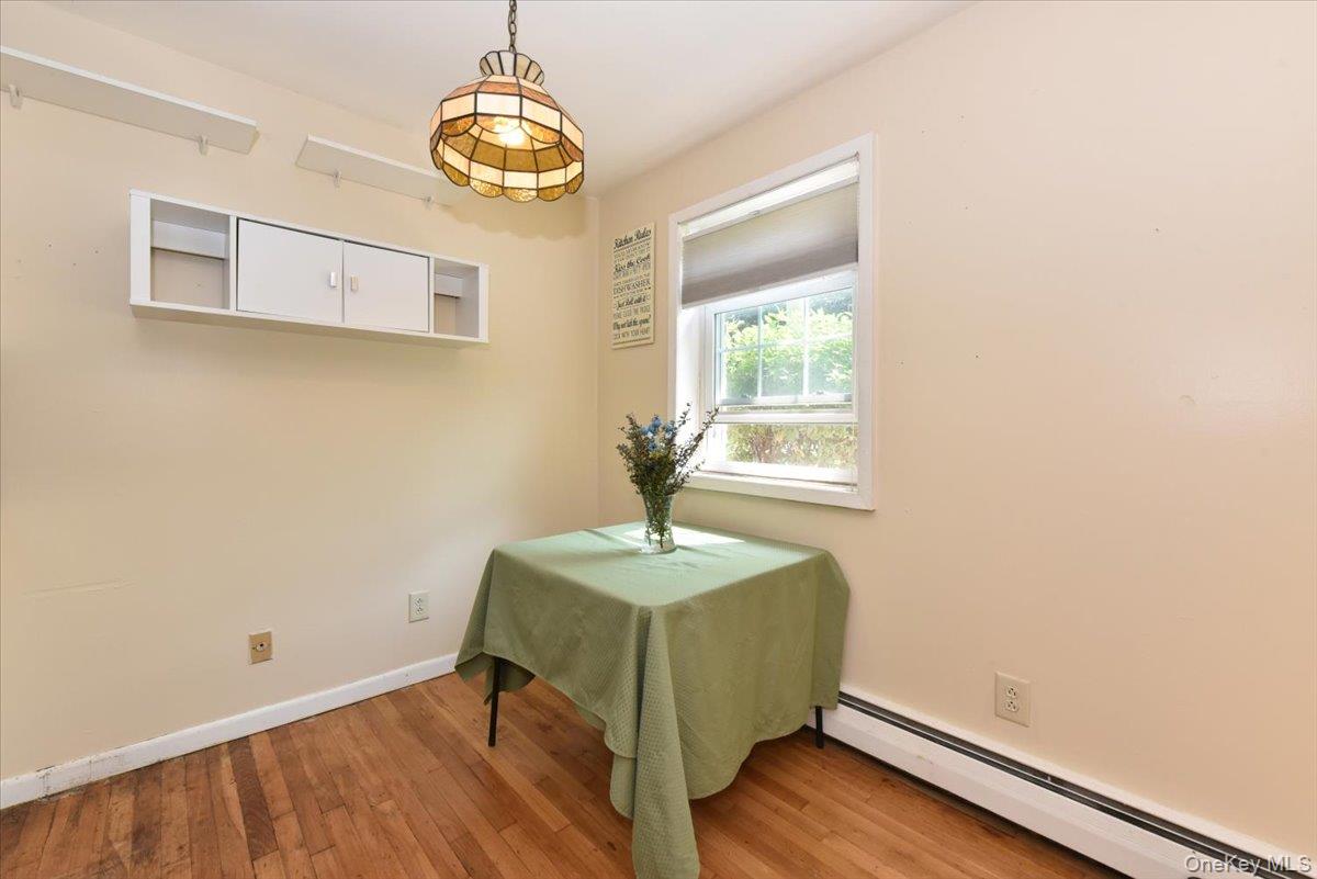 295 Merrick Road, Unit 4A Amityville, NY 11701 - Photo 7 of 16 a room with a wooden floor and a window
