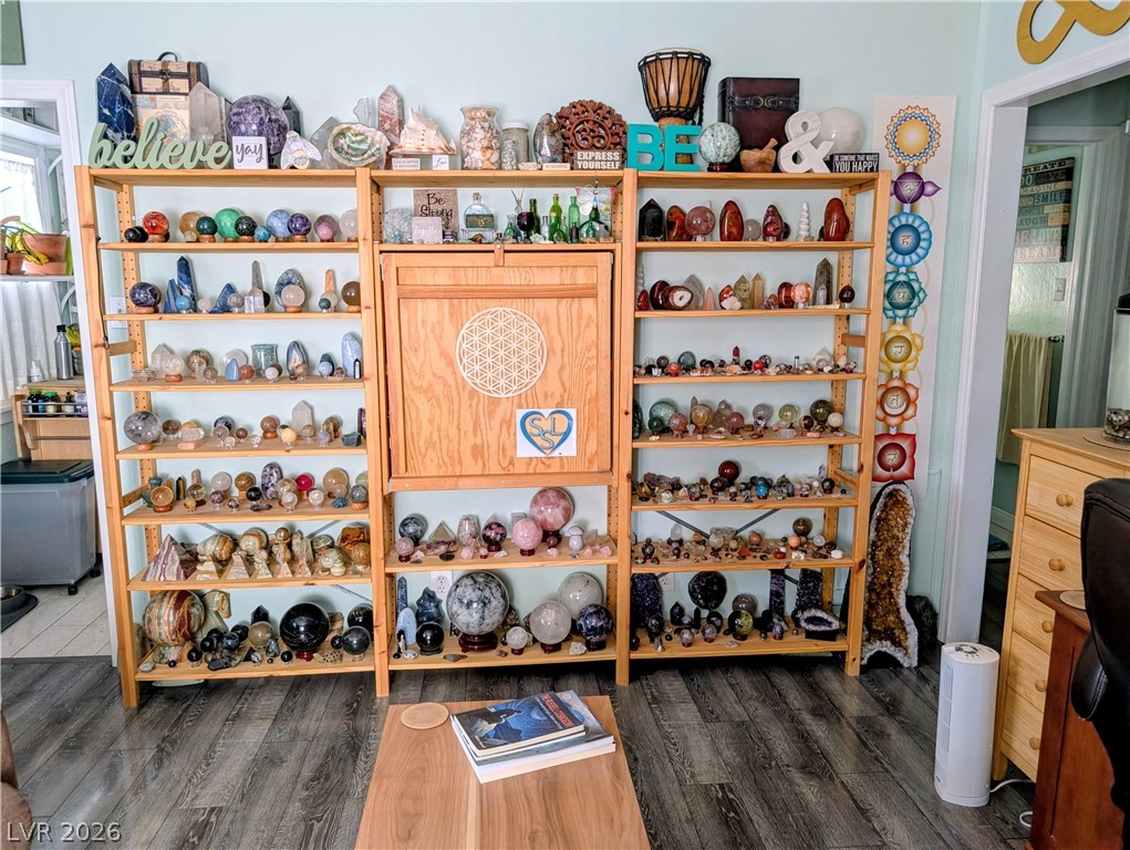 102 Rowan Drive Caliente, NV 89008 - Photo 8 of 28 Hardwood floors complement the custom shelving, perfect for displaying unique collections.