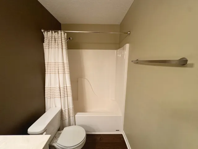 a white toilet sitting next to a bathroom sink