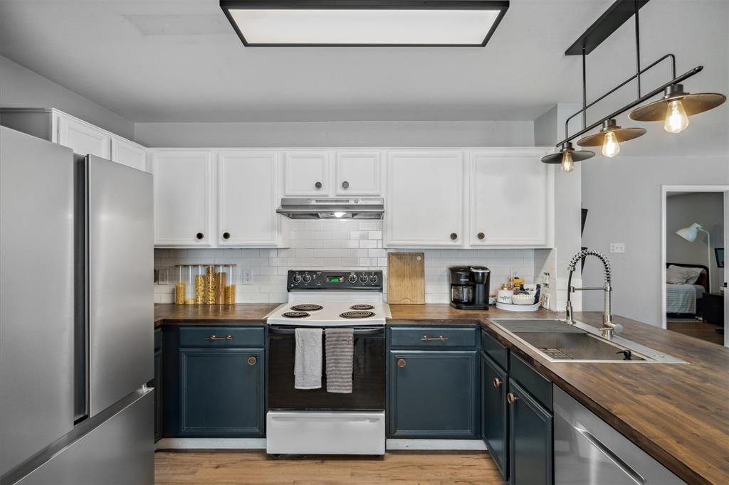 106 Rio Grande Drive Crandall, TX 75114 - Photo 11 of 40 a kitchen with stainless steel appliances granite countertop a sink stove and refrigerator