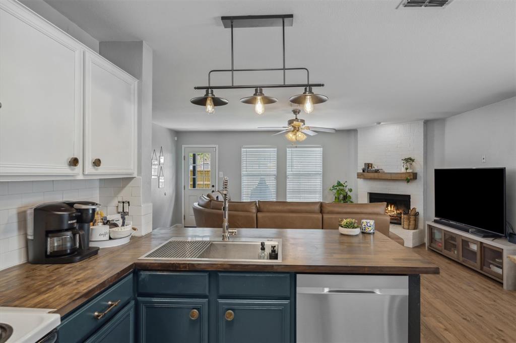 106 Rio Grande Drive Crandall, TX 75114 - Photo 12 of 40 a kitchen with stainless steel appliances a sink and a stove top oven