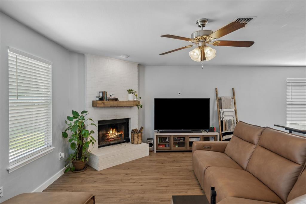 106 Rio Grande Drive Crandall, TX 75114 - Photo 15 of 40 a living room with furniture a fireplace and a flat screen tv