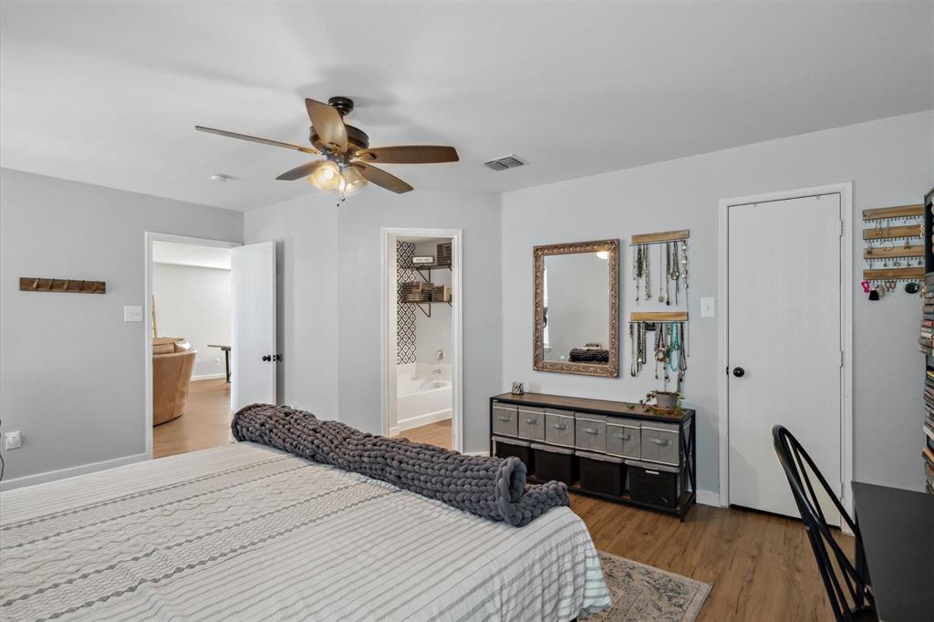 106 Rio Grande Drive Crandall, TX 75114 - Photo 23 of 40 a bedroom with a bed and a chandelier