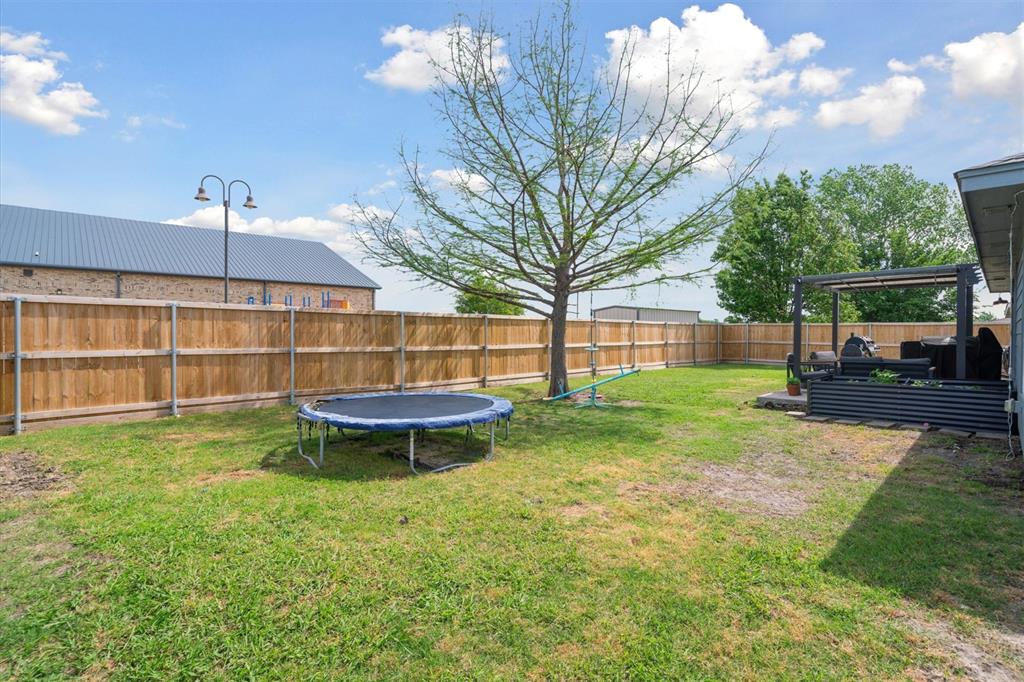 106 Rio Grande Drive Crandall, TX 75114 - Photo 39 of 40 a view of a backyard with a garden and entertaining space