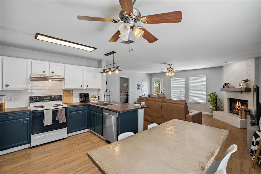 106 Rio Grande Drive Crandall, TX 75114 - Photo 8 of 40 a kitchen with stainless steel appliances kitchen island granite countertop a refrigerator a stove sink and dishwasher with wooden floor