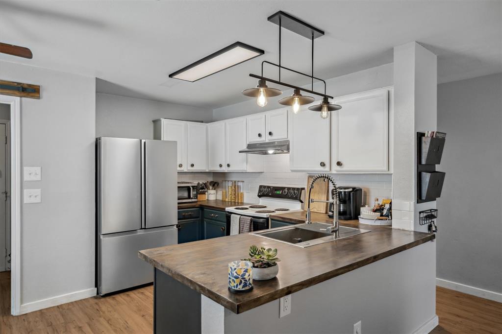 106 Rio Grande Drive Crandall, TX 75114 - Photo 10 of 40 a kitchen with kitchen island a counter appliances and cabinets