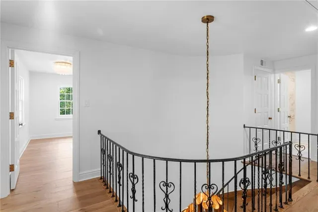 a view of hallway with wooden floor