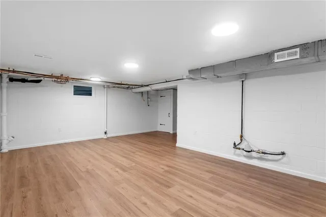 a view of a room with wooden floor and a ceiling fan