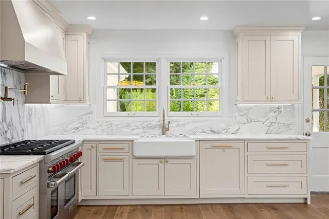 a kitchen with granite countertop a sink and a stove