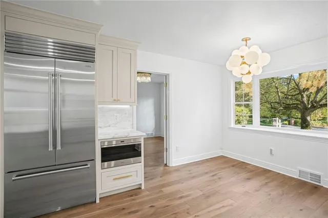 a kitchen with a refrigerator and windows