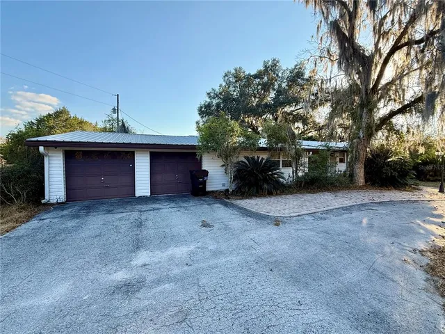 a view of a house with a yard and garage