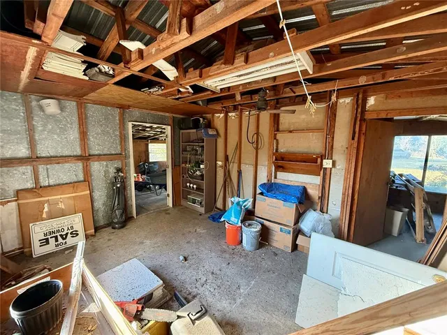 a view of dirt field with trees in the background
