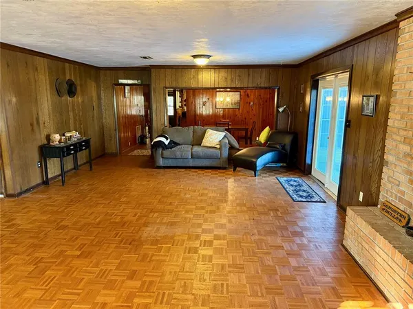 a room with furniture pool table and window