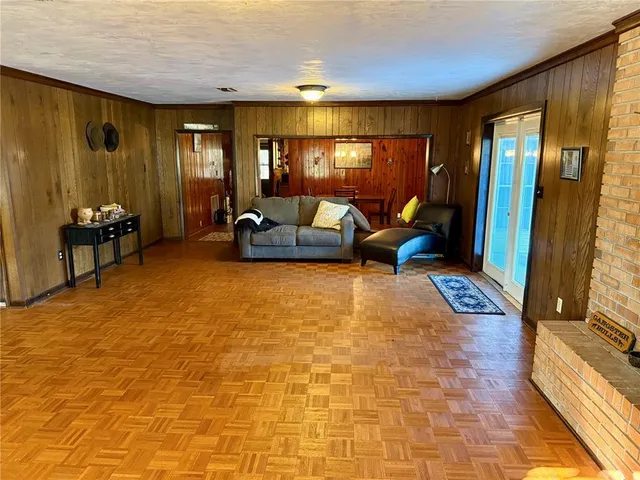 a room with furniture pool table and window