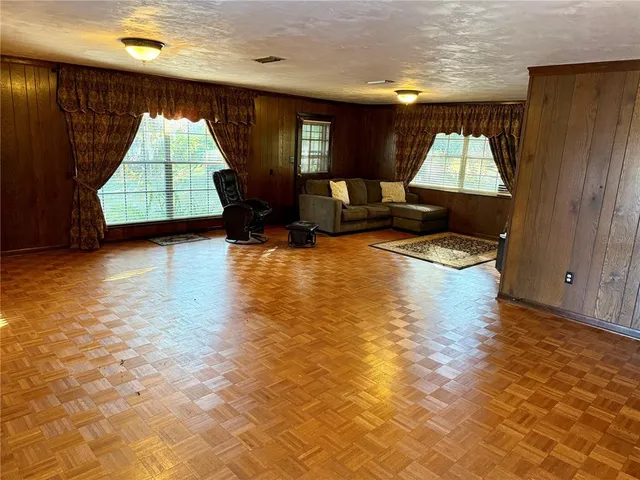 a kitchen with stainless steel appliances kitchen island granite countertop a sink a stove and cabinets