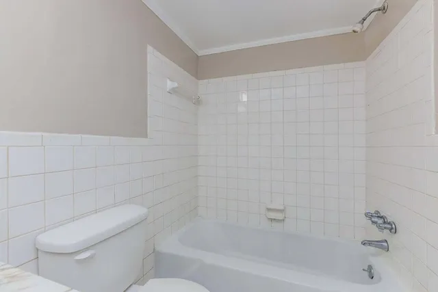 a bathroom with a toilet and bathtub