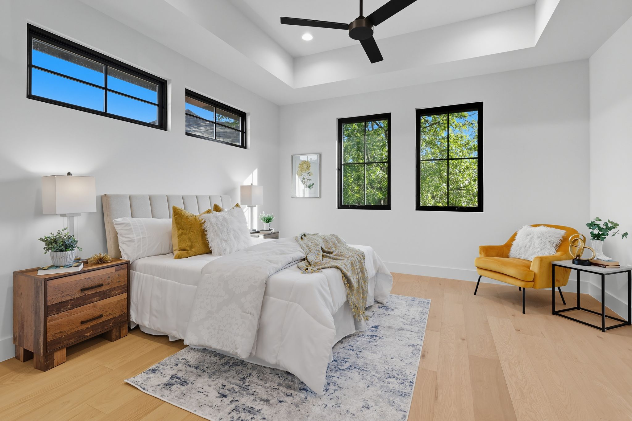 5012 Highland Court Austin, TX 78731 - Photo 22 of 32 Bedroom featuring light wood-type flooring, a raised ceiling, ceiling fan, and recessed lighting