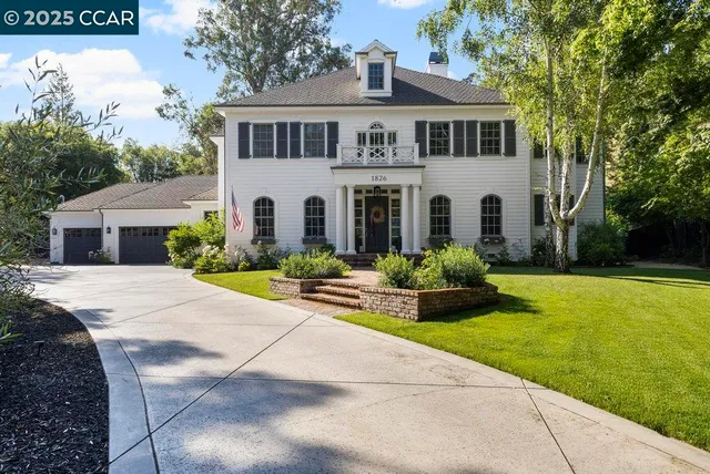 a front view of a house with yard and green space