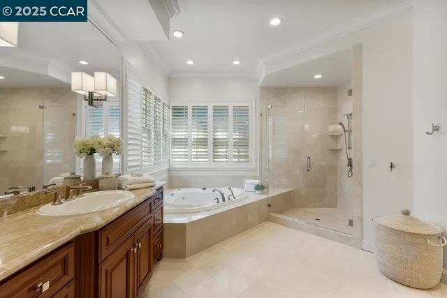 a spacious bathroom with a granite countertop tub sink shower and mirror