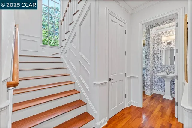 a view of entryway with wooden floor and stairs