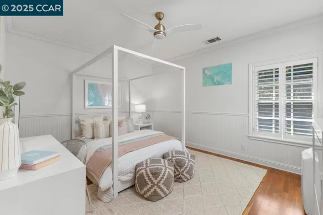 a bedroom with a bed window and a table