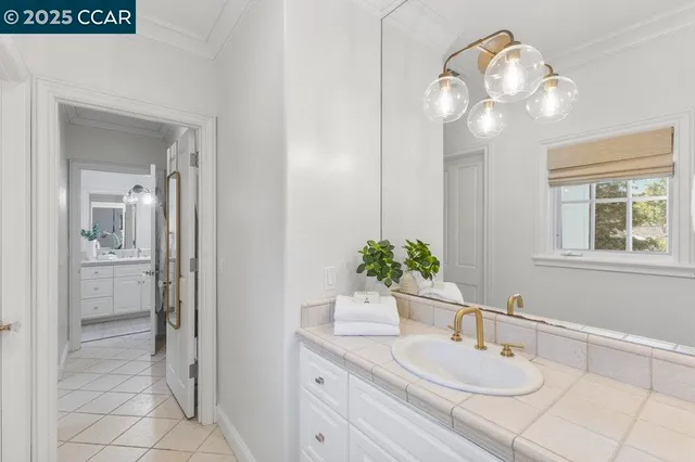a bathroom with a granite countertop sink a large mirror and a shower