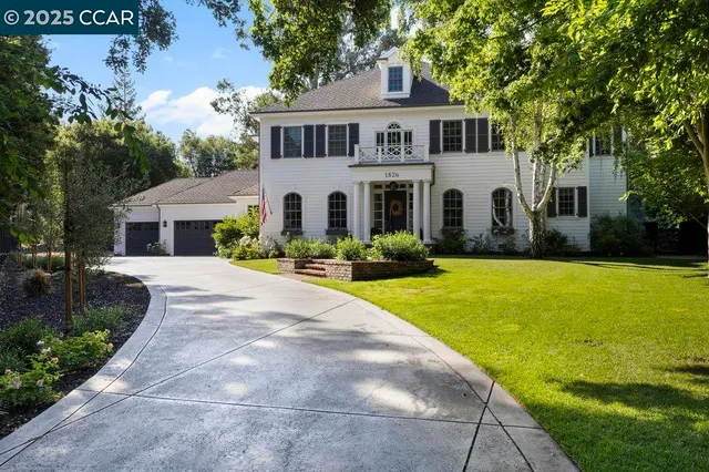 a front view of a house with swimming pool and green space