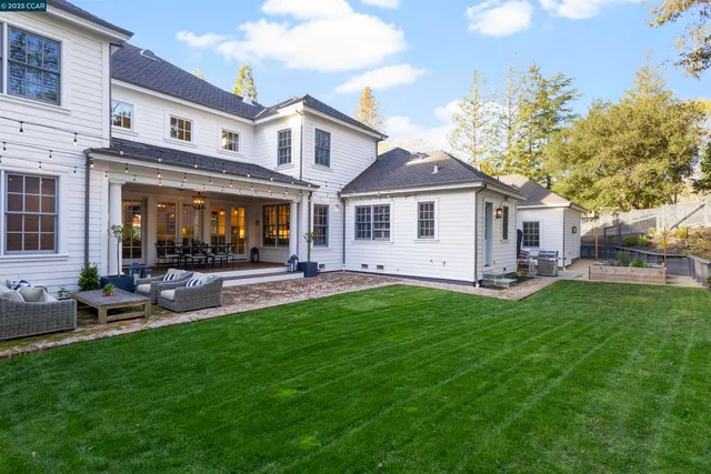 a front view of a house with a garden and patio