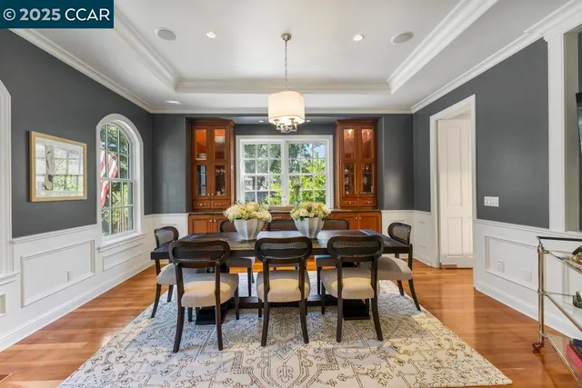 a view of a a dining room with furniture window and wooden floor
