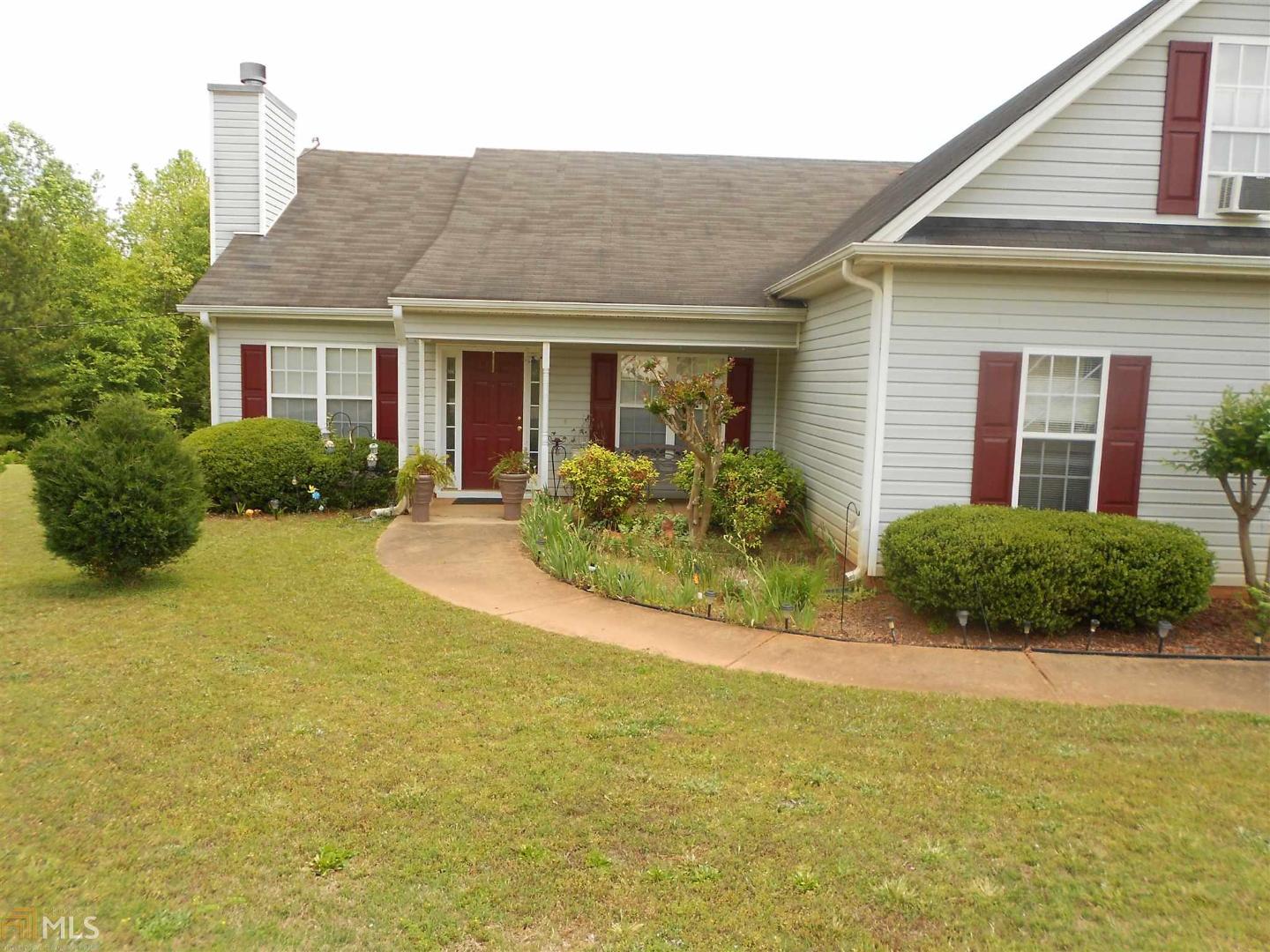 145 Spring Valley Trace Covington, GA 30016 - Photo 1 of 1 a front view of a house with a yard