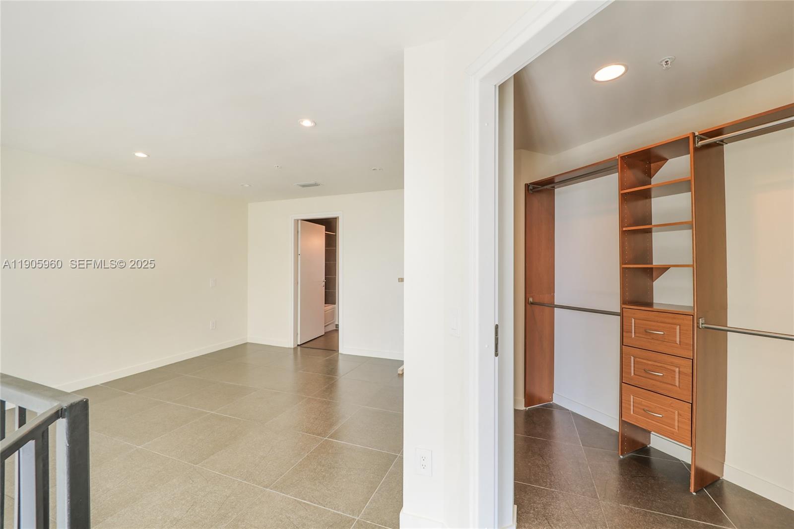 300 South Biscayne Boulevard, Unit L414 Miami, FL 33131 - Photo 16 of 21 a view of walk in closet with empty racks