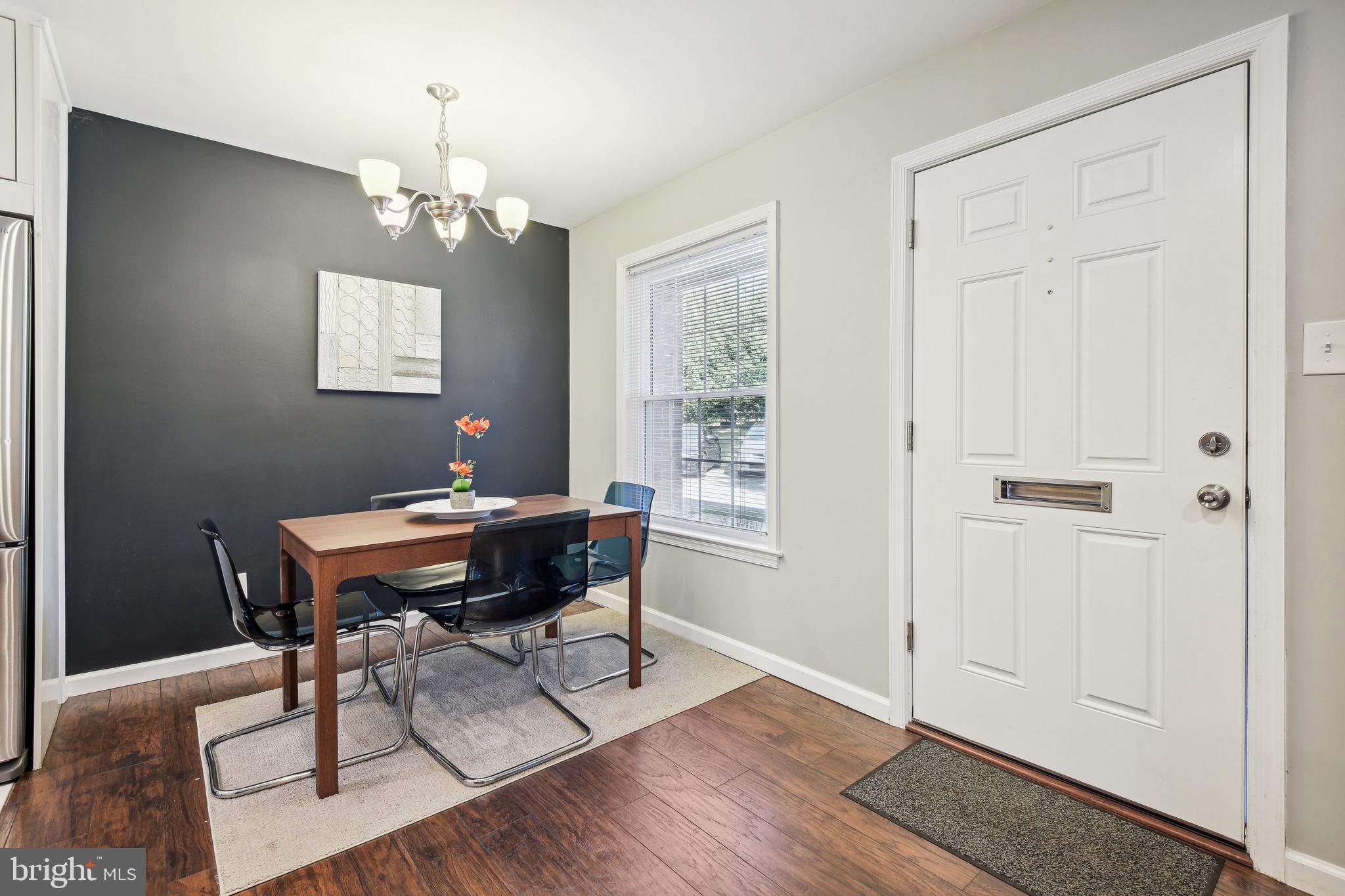 1925 Lyttonsville Road, Unit 1925 Silver Spring, MD 20910 - Photo 9 of 24 Dining area with accent wall and light fixture