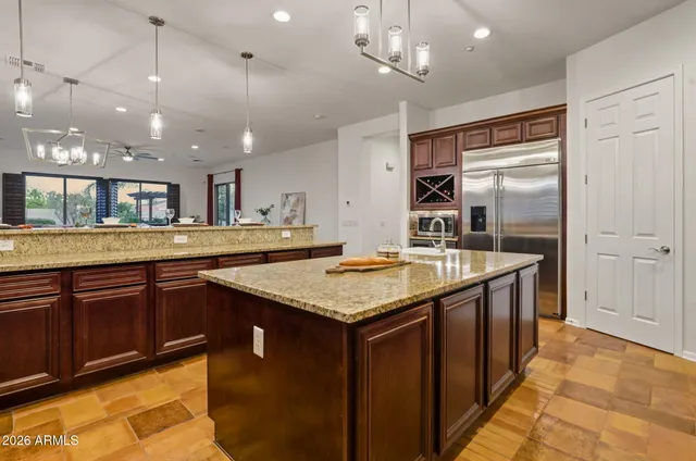 a kitchen with center island and stainless steel appliances