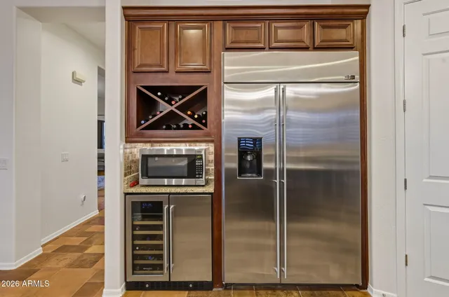 a kitchen with a refrigerator and a sink